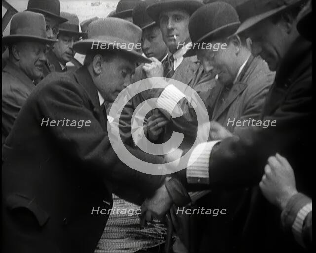 A Group of Male Civilians Volunteers Being Issued With White Arm Bands, 1926. Creator: British Pathe Ltd.