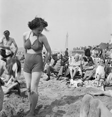 A young woman in a knitted bathing costume on the beach, Blackpool, c1946-1955. Artist: John Gay