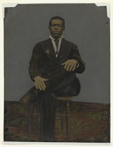 Tintype of a man wearing a suit with a pendant on the lapel, early 20th century. Creator: Unknown.