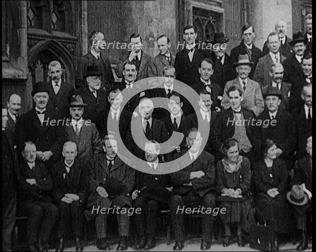 Prime Minister Ramsay MacDonald Sitting on a Chair Smoking Whilst Surrounded by Members of..., 1924. Creator: British Pathe Ltd.