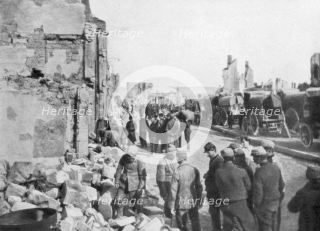 Captive German prisoners removing debris from the streets of Clermont-en-Argonne, France, 1914. Artist: Unknown
