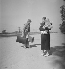 Young family, penniless, hitchhiking on U.S. Highway 99 in California, 1936. Creator: Dorothea Lange.