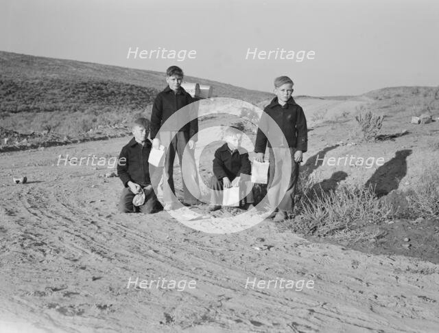 Boys wait for school bus in the morning, Malheur County, Oregon, 1939. Creator: Dorothea Lange.