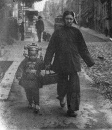 Carrying New Year's presents, Chinatown, San Francisco, between 1896 and 1906. Creator: Arnold Genthe.
