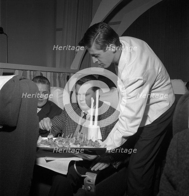SAS steward serving snacks on a flight, 1960. Artist: Torkel Lindeberg