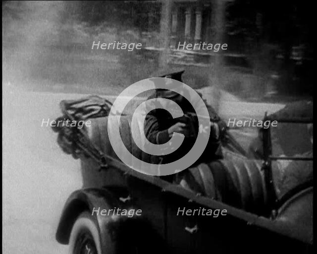 Male American Police Officers on a Car Shooting a Gunmachine on Persue, 1930. Creator: British Pathe Ltd.