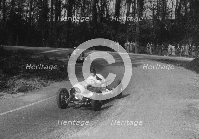 Riley of Hector Dobbs leading the MG Q type of Kenneth Evans, Donington Park, Leicestershire, 1935. Artist: Bill Brunell.