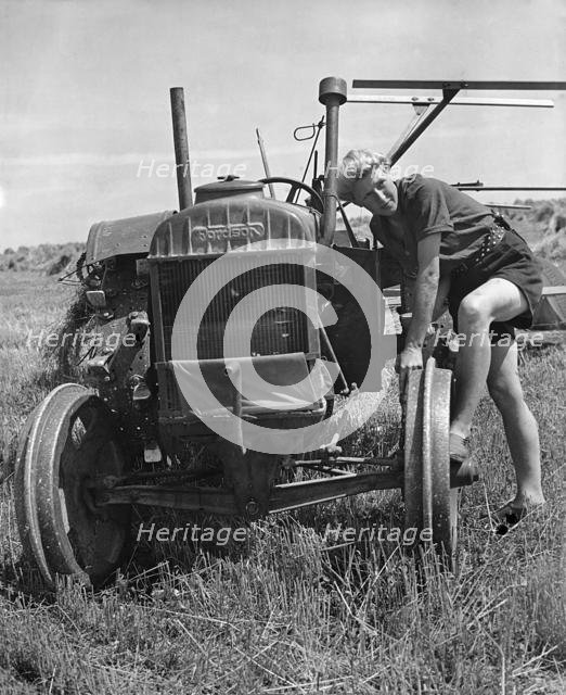 Fordson tractor, with Land girl 1940's. Creator: Unknown.