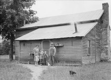 Tobacco sharecroppers and family at back of their house, Person County, North Carolina, 1939. Creator: Dorothea Lange.