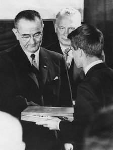 Robert F Kennedy accepts his brother's award from President Lyndon Johnson, December 1963. Artist: Unknown