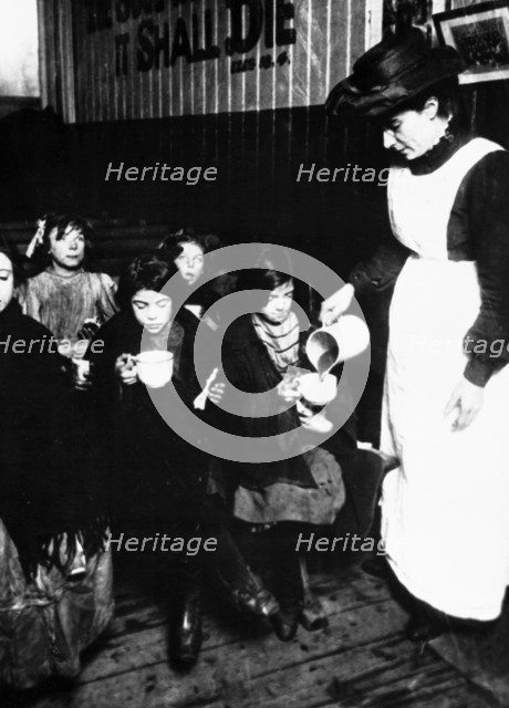 Slum sister giving out farthing breakfast, London. Artist: Unknown