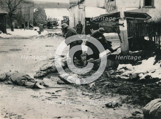 German troops stripping the equipment of dead American troops, Belgium. Artist: Unknown