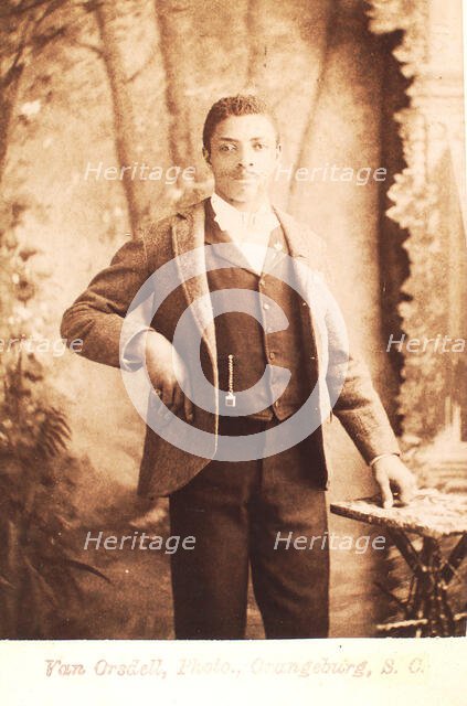 Studio portrait of man, hand on waist, (1880-1940?). Creator: Van Orsdell.