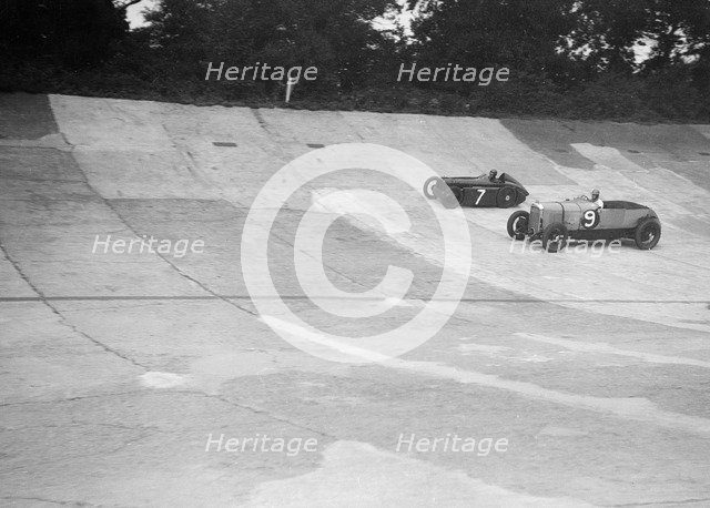 Austin 747 cc works racer and another car on the Members Banking at Brooklands. Artist: Bill Brunell.