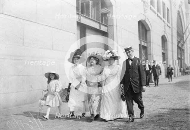 Mrs. Mills, Mrs. Hyde, Mrs. Ginnett, a detective and a little girl walking down the street..., 1910. Creator: Bain News Service.