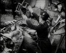 Scrap Metal Being Thrown into a Pile, 1936. Creator: British Pathe Ltd.