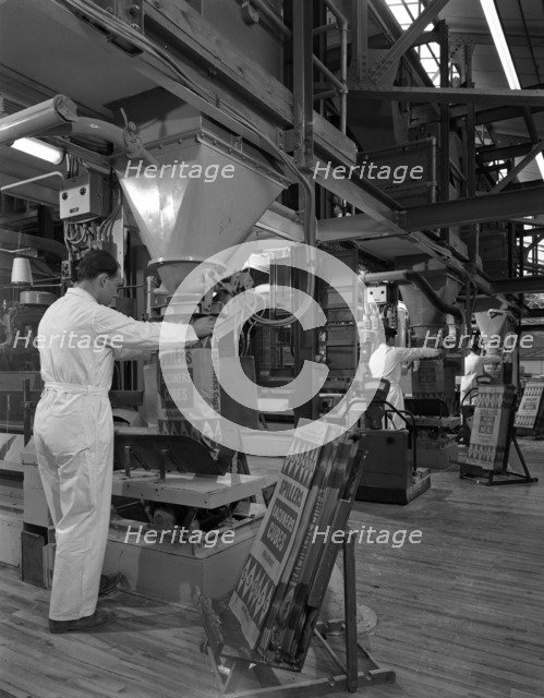 Filling bags of animal feed, Spillers Animal foods, Gainsborough, Lincolnshire, 1963. Artist: Michael Walters