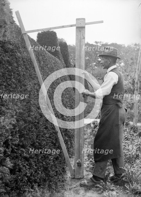 A gardener in the grounds of Great Dixter, East Sussex, c1919-c1933. Artist: Nathaniel Lloyd