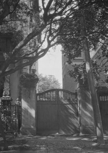 Gate between two buildings, New Orleans, or Charleston, South Carolina, between 1920 and 1926. Creator: Arnold Genthe.