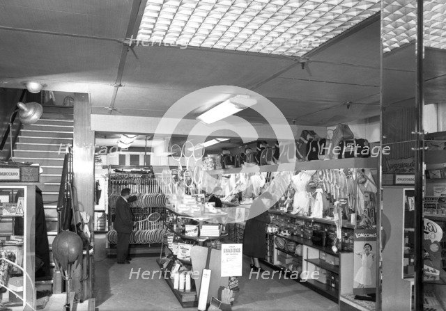 Customers in the Barnsley Co-op's sports department, South Yorkshire, 1957. Artist: Michael Walters
