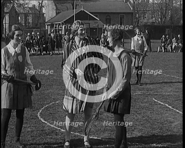 A Female Civilian Tossing a Coin in Front of Two Young Female Lacrosse Players Ahead of the..., 1920 Creator: British Pathe Ltd.