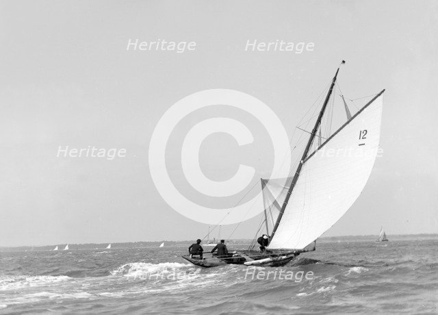 The 8 Metre sailing yacht 'Dilkusha' setting spinnaker, 1911. Creator: Kirk & Sons of Cowes.