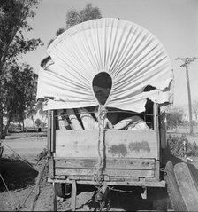Covered wagon, migratory carrot puller's camp, near Holtville, Imperial Valley, 1939. Creator: Dorothea Lange.