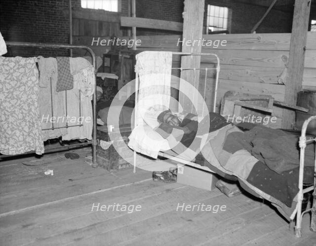 Sick flood refugee in the Red Cross temporary infirmary at Forrest City, Arkansas, 1937. Creator: Walker Evans.