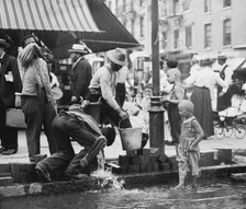 Summer scene, N.Y. - drinking water from street pump, between c1910 and c1915. Creator: Bain News Service.