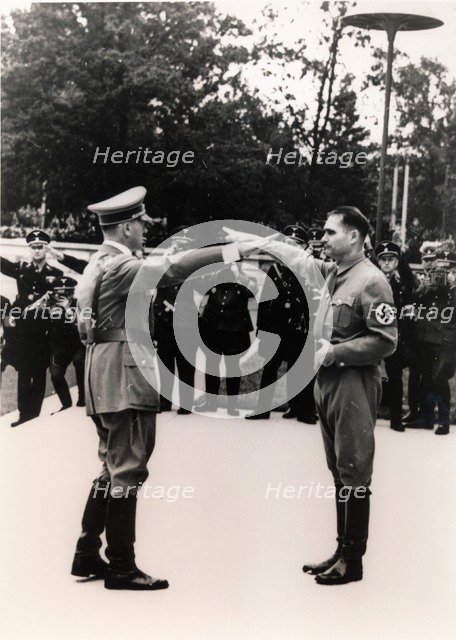 Nazi leaders Adolf Hitler and Rudolf Hess exchanging salutes, c1930s-c1940s. Artist: Unknown