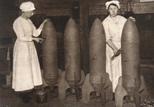 Women munitions workers putting a coat of paint on aerial bombs, World War I, c1914-c1918. Artist: S and G