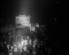 Buses and Crowds of People on a Busy London Street at Night, 1920s. Creator: British Pathe Ltd.