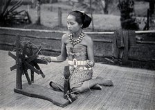 Sarawak: a girl spinning cotton into thread, c1900. Creator: Unknown.