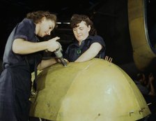 Working on a "Vengeance" dive bomber, Vultee [Aircraft Inc.], Nashville, Tennessee, 1943. Creator: Alfred T Palmer.