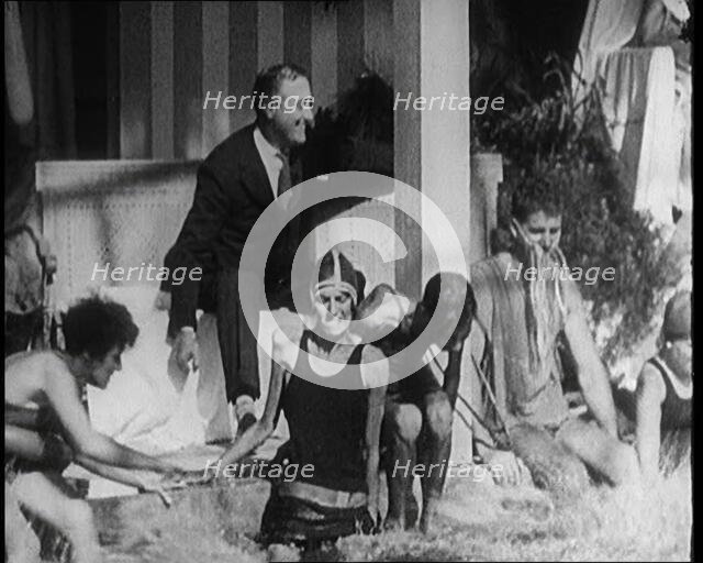 American Politician Franklin Delano Roosevelt Laughing as People Around Him Are Jumping..., 1921. Creator: British Pathe Ltd.