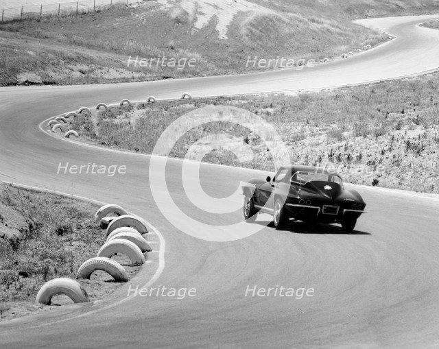 1964 Chevrolet Corvette Stingray on a winding racetrack, (c1964?). Artist: Unknown