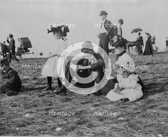 Parents and children seated on grass at state fair, St. Paul, Minnesota, 1900?. Creator: Unknown.