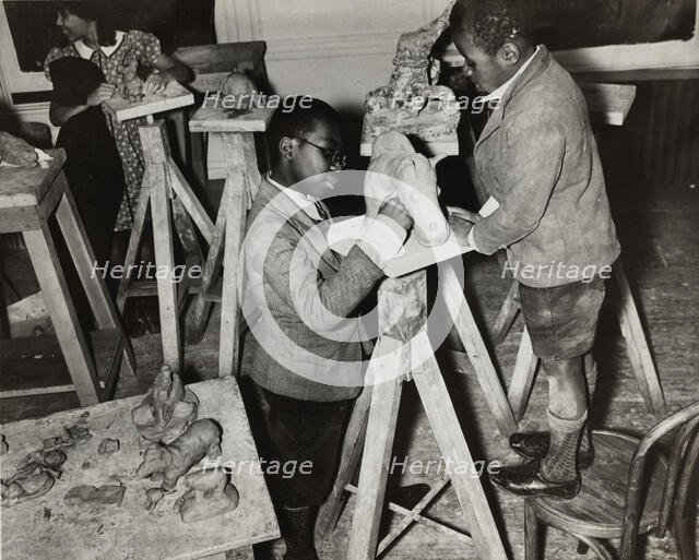 Boys sculpting a horse, Harlem Community Art Center, 1937. Creator: Solomon Horn.