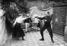 Man and woman fencing (?), between c1910 and c1915. Creator: Bain News Service.