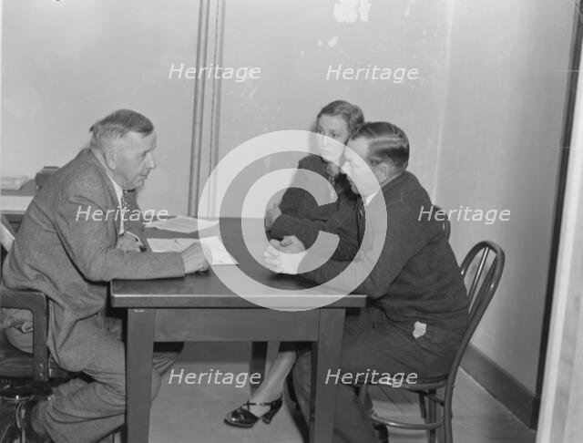 Night meeting in the FSA office, Visalia, Tulare County, California, 1938. Creator: Dorothea Lange.