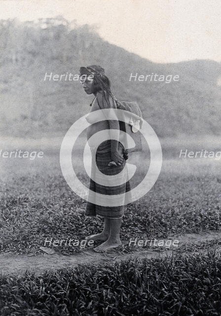 Sarawak: a Kayan woman carrying her child in a sling, c19th century. Creator: Unknown.