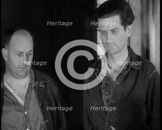 A group of Male Americans Civilians Wearing Prisoners Outfits Being Escorted Into a Room..., 1930. Creator: British Pathe Ltd.