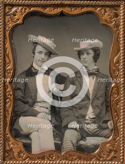 Two Seated Young Men Wearing Gingham Trousers, Bow Ties, and Brimmed, Soft Hats, 1850s. Creator: Unknown.