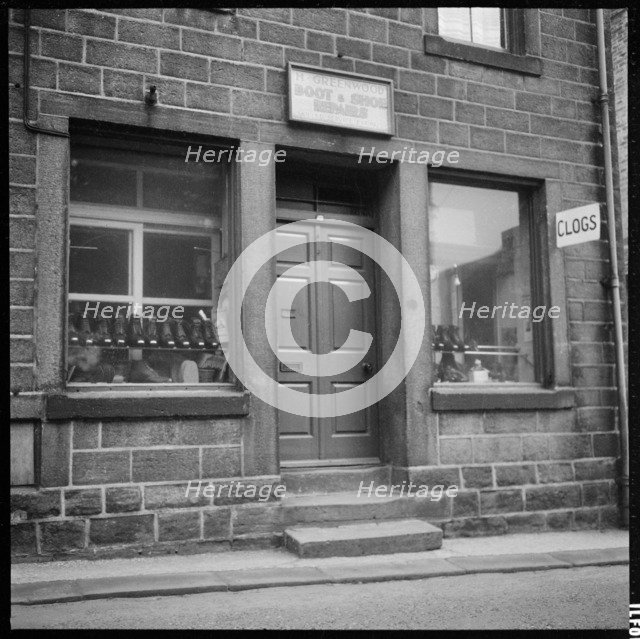 Clogs displayed in the window of H Greenwood Boot & Shoe Repairs shop, 1966-1974. Creator: Eileen Deste.