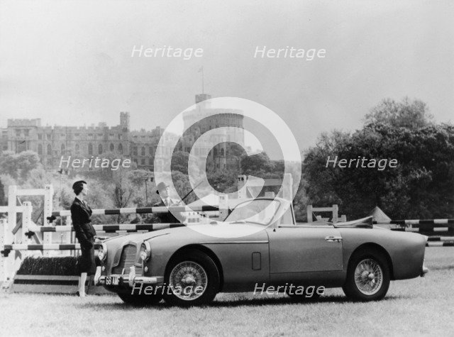 An Aston Martin DB2-4 MKII, with Windsor Castle in the background, 1956. Artist: Unknown