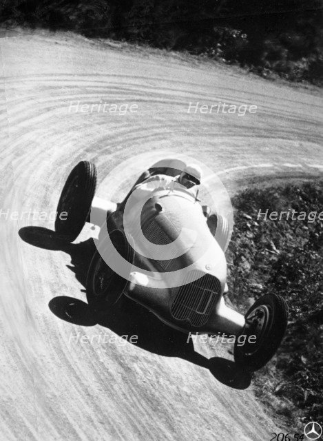 Manfred von Brauchitsch driving Mercedes-Benz W25 Grand Prix car, 1934. Artist: Unknown