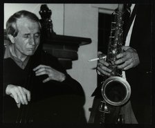 Phil Bates and the tenor saxophone of Spike Robinson at The Bell, Codicote, Hertfordshire, 1986. Artist: Denis Williams