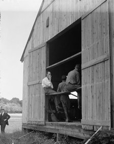 Wright Flights, Fort Myer, Va, July 1909 - Hangar, Wilbur Wright, Right, Showing His Objection To... Creator: Harris & Ewing.