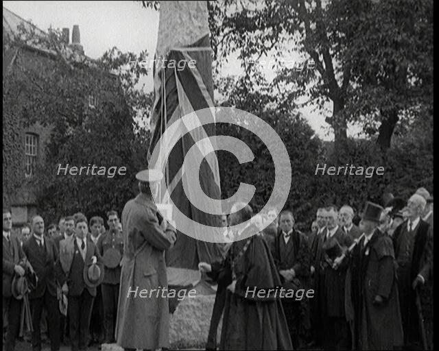 British Officer Pulling Down Union Flag to Reveal a Memorial Obelisk, 1920. Creator: British Pathe Ltd.