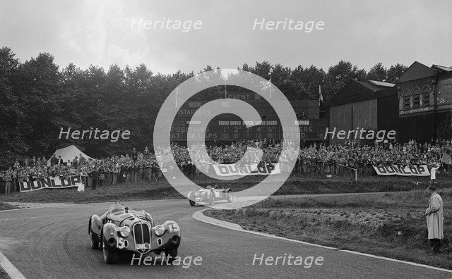 Alfa Romeo of Hugh Hunter leading a Riley at Crystal Palace, London, 1939. Artist: Bill Brunell.